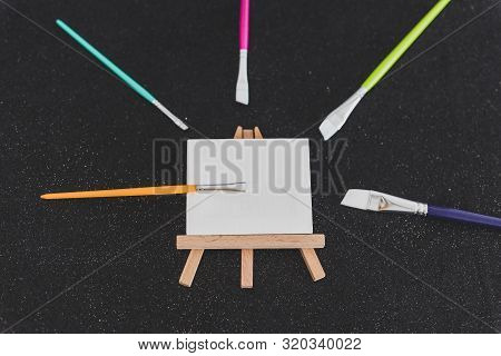 Mini Blank Canvas And Paintbrush With Copyspace