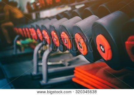 Rows Of Metal Dumbbells On Rack In Sport Fitness Gym Center . Weight Training Equipment Sport And He