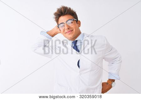 Young handsome sciencist man wearing glasses and coat over isolated white background stretching back, tired and relaxed, sleepy and yawning for early morning