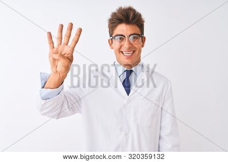Young handsome sciencist man wearing glasses and coat over isolated white background showing and pointing up with fingers number four while smiling confident and happy.