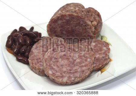Cooked Cotechino Salame With Beans Served On A Plate