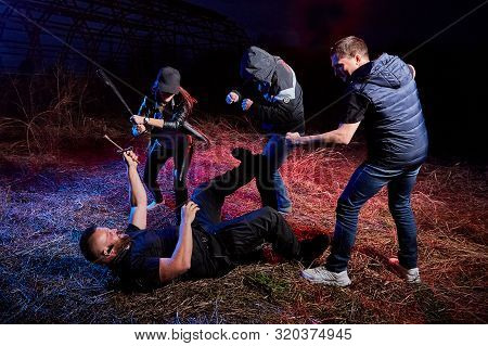 Fight Four Bandits In The Field At Night. Photoshoot About Life Of Gungsters In Russia