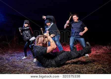 Fight Four Bandits In The Field At Night. Photoshoot About Life Of Gungsters In Russia