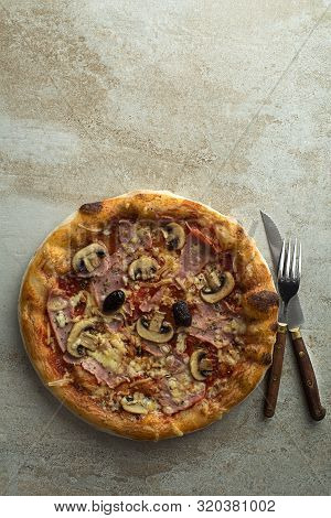 Pizza Served With Mozzarella Cheese, Ham, Mushrooms And Tomato Sauce