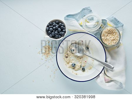 Eating Porridge Oatmeal With Fruits, Berries, And Honey. Concept Of Healthy Breakfast, Wellbeing, He