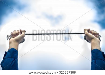 Close Upraised Hands Of A Young Businessman Wearing A Blue Colored Suit And Black Colored Necktie Wi