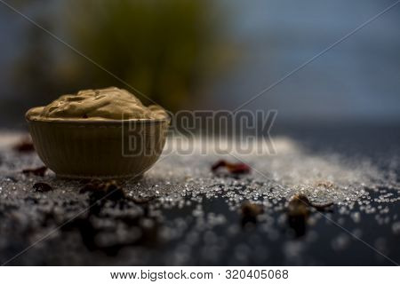Ubtan/face Mask/face Pack Of Multani Mitti Or Fuller's Earth On Wooden Surface In A Glass Bowl Consi