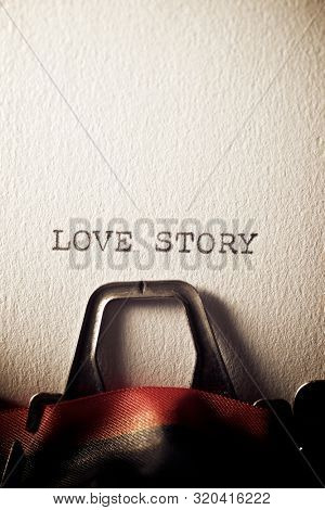 The sentence, Love Story, written with a typewriter.