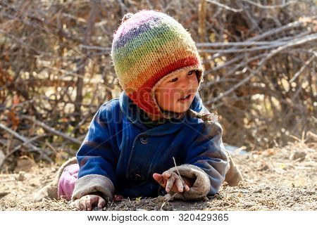 Jhong, Nepal - November 17, 2015: Little Nepali Child Playing On The Ground.