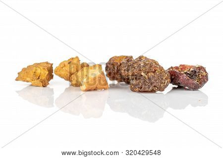 Group Of Six Pieces Of Raisins And Roseship Of Lingonberry Strawberry Fruit Tea Macro Isolated On Wh