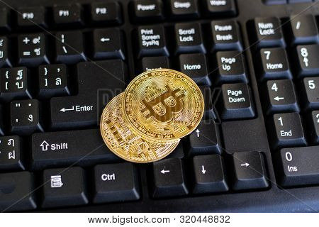 Bitcoin With Black Keyboard On Old Wood