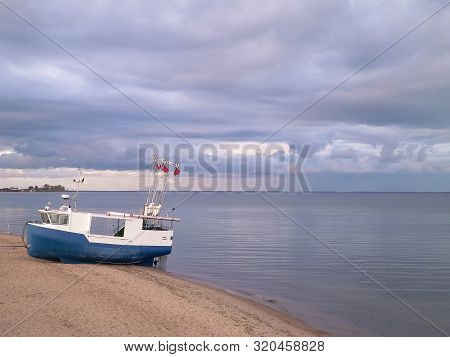 Fishing Boat On Baltic Sea Coast. Stormy Weather. Mechelinki, Poland, Pucka Bay.