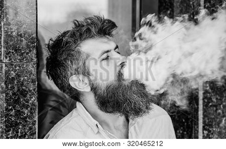 Smoking Electronic Cigarette. Stress Relief Concept. Smoking Device. Man Long Beard Relaxed With Smo