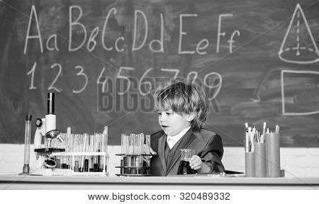 Educational Experiment. Happy Childhood. Boy Near Microscope And Test Tubes School Classroom. Knowle