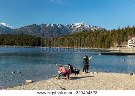 Eibsee, Germany, March 31, 2019: Tourists Taking Selfie On Them Self While Enjoying Holidays At Eibs