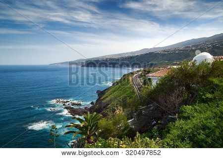 Coastline Of The Atlantic Ocean With Mountains And Road View In Puerto De La Cruz, One Of The Popula