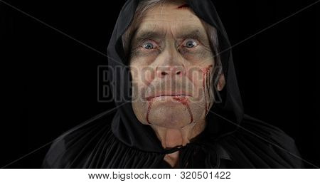 Old Executioner Halloween Man Portrait. Elderly Man With Dripping Blood On His Face. Executioner, He