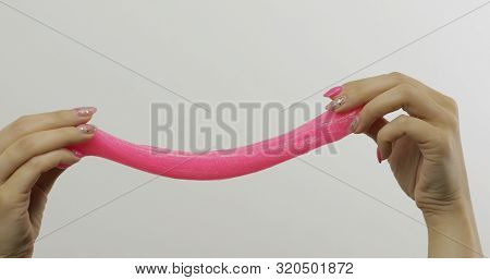 Woman Hands Playing With Oddly Satisfying Pink Slime On White Background. Sticky Gooey Substance. Re