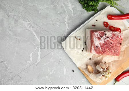 Flat Lay Composition With Pork Fatback And Spices On Grey Table, Top View. Space For Text