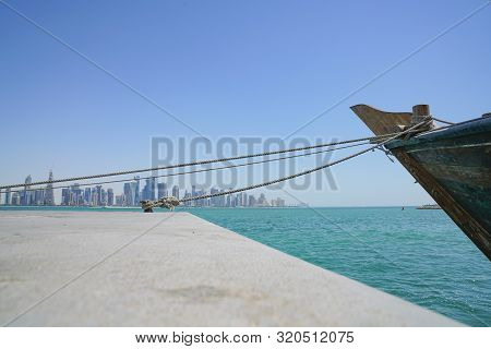 Al Dafna Architecturally Modern Sykline Across Dhow Harbour With Bow And Mooring Ropes In Doha  Qata