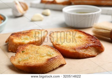 Slices Of Delicious Toasted Bread With Garlic On Table, Closeup