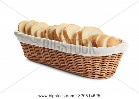 Slices Of Tasty Fresh Bread In Wicker Basket On White Background