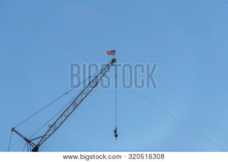 Metal Construction Crane Viewed From Below Against Cloudless Blue Sky