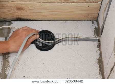 Electrican Installing Electrical Wires In Wall. Installation Electrical Wiring