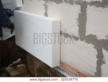 Insulation House Wall Outdoors. Builder Installing Rigid Styrofoam Insulation Board For Energy Savin