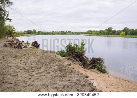 City Carnikava, Latvian Republic. Fisherman Catching Fish In The River, Nature, Silence And Water Wa