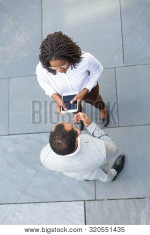 Business Team Meeting Near Office And Discussing Work Issues. Top View Of Business Man And Woman Sta
