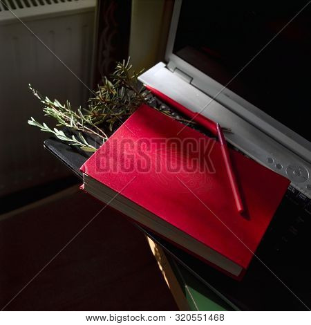 Red Book And Oencil Laid On The Laptop, Indoor Close-uip Shot, Square Composition