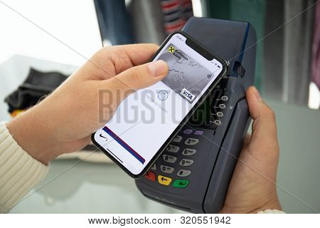 Anapa, Russia - August 12, 2019: Man Hand Holding Iphone X With Apple Pay On The Screen And Pay Pass