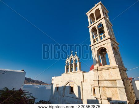 Low Angle Of Historic Stone Building Of Monastery Of Panagia Tourliani With Tower On Sunny Summer Da