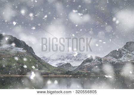 Beautiful Sunrise Landscape Image In Winter Of Llyn Nantlle In Snowdonia National Park With Snow Cap