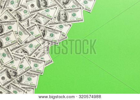 Top View Banknotes On Colored Desk With Copy Space On Top. One Hundred Dollar Bills With Stack Of Mo