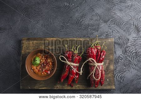 Spicy Chili On A Dark Background In Ceramic Plates On A Wooden Board, Flatlay. Used As An Ingredient