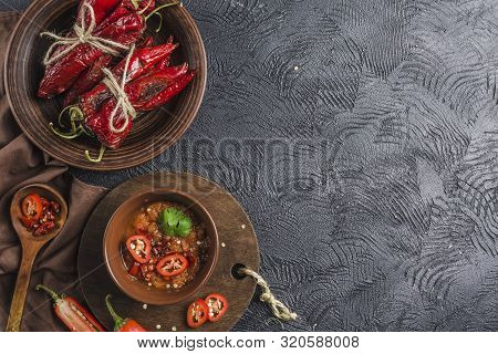 Spicy Chili On A Dark Background In Ceramic Plates, Flatlay. Used As An Ingredient For Harissa, Ajik