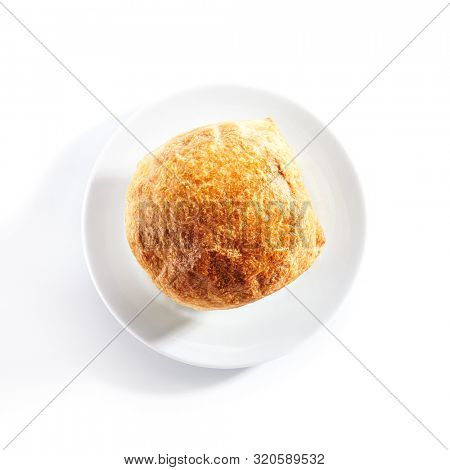 Top view of julienne or potage soup with chicken and mushrooms topped with melted cheese or puff pastry on white restaurant plate isolated. Stew baked in white bowl with bread on top topview