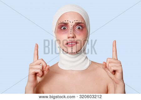 Close Up Of Female With Scared Facial Expressing Waiting For Medical Procedure. Woman Wearing Bandag