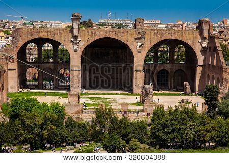Rome, Italy - April, 2018: Tourists At The Basilica Of Maxentius And Constantine In The Roman Forum 