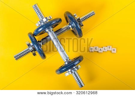Healthcare Concept Showing Dumbbells And The Message Health