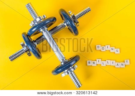 Healthcare Concept Showing Dumbbells And The Message Doing Brilliant