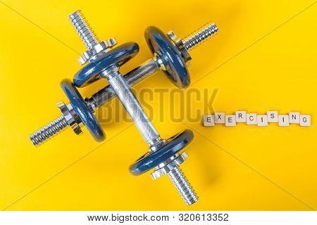 Healthcare Concept Showing Dumbbells And The Message Exercising