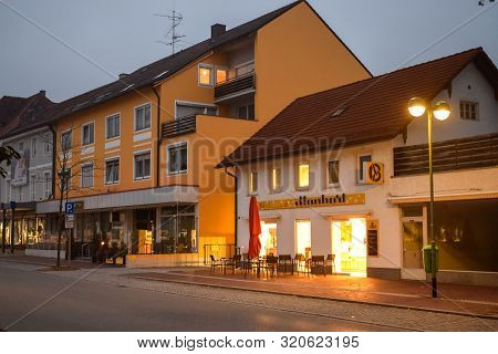 Buchloe, Germany - Oktober 09, 2018: Light From Cafe On An Empty Street In The Morning In Buchloe Ge
