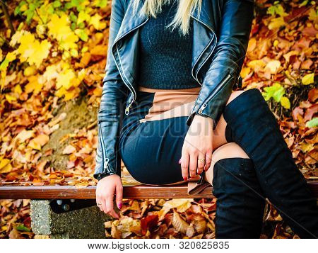 Female Wearing Sexy Autumn Outfit. Woman Having Short Pink Skirt, Leather Jacket And High Knee Black