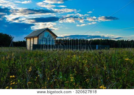 The landscape with the image of meadow at sunset