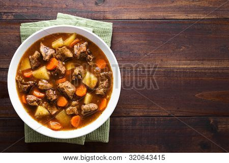 Fresh Homemade Beef Stew With Carrot And Potatoes Served In Bowl, Photographed Overhead With Copy Sp