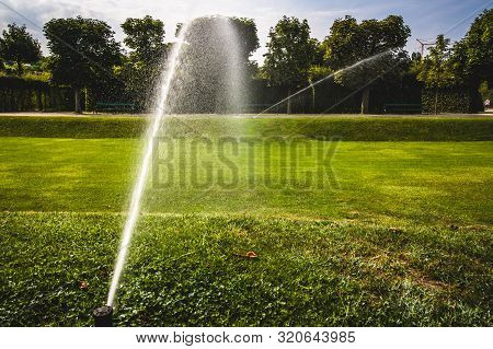 Automatic Watering Equipment, Lawn Maintenance, Gardening And Tools Concept. Smart Garden Activated 