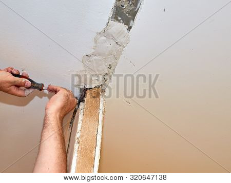 Man Repairing A Wall